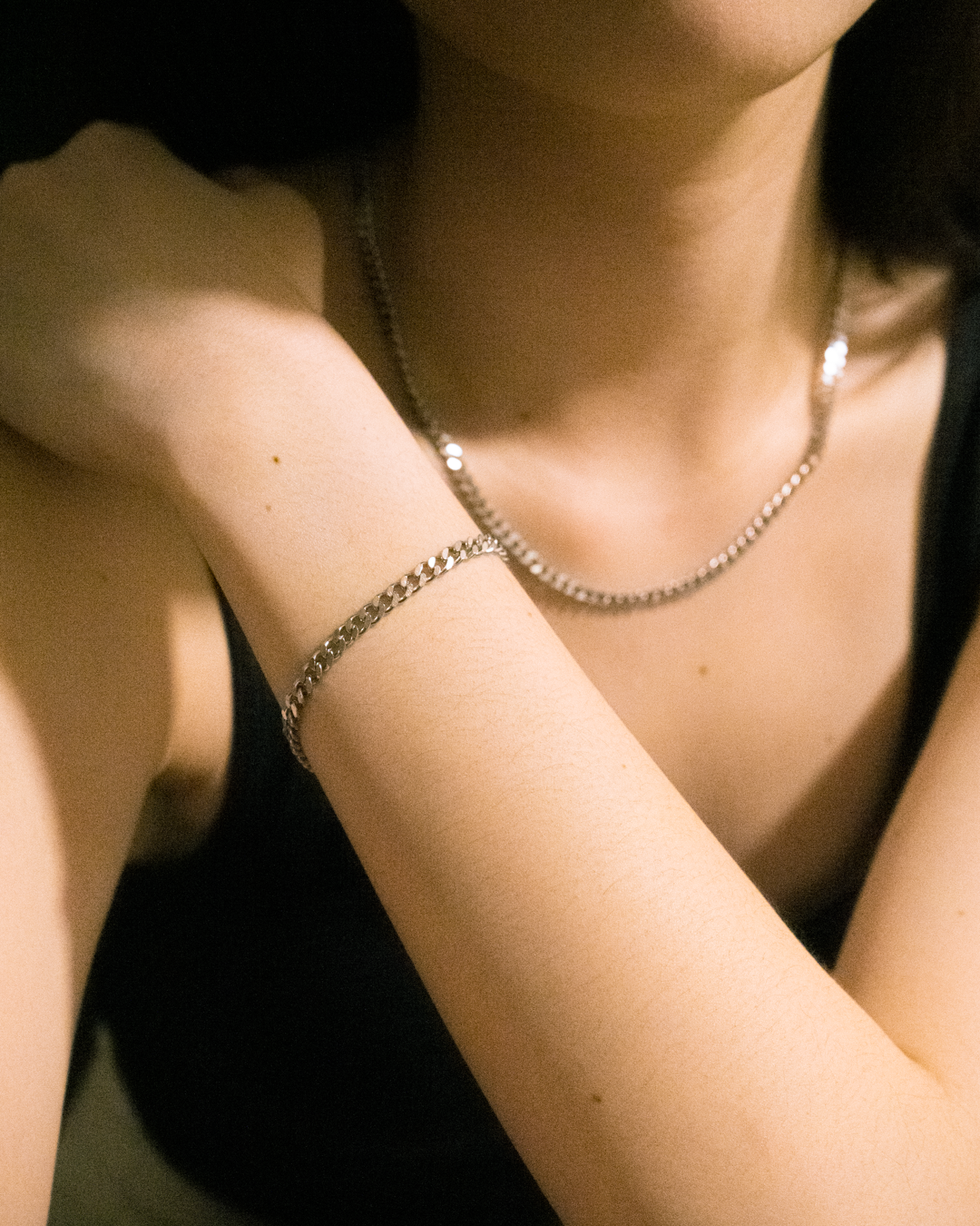 Model is wearing the 4mm Curb Bracelet and Necklace.